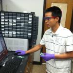 Hoang Dang studying coin cell test results.